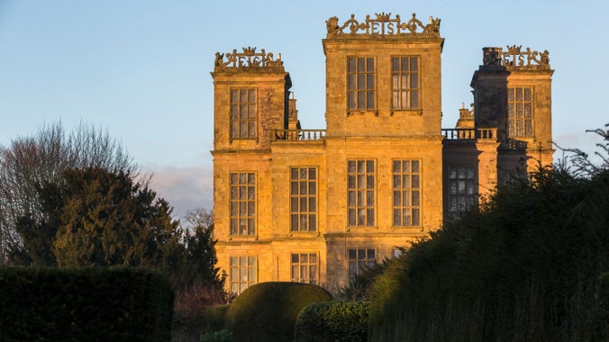 The south elevation of Hardwick Hall in winter light with the formal gardens in front. The sun highlights all the details of the hall.